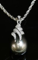 Lot 274 - A 9ct white gold Tahitian pearl and diamond pendant and chain