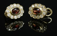Lot 309 - A pair of gold garnet and diamond cluster earrings