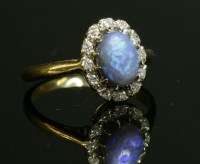 Lot 42 - A black opal and diamond oval cluster ring
