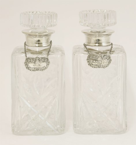 Lot 565 - A pair of Elizabeth II cut-glass and silver-mounted decanters