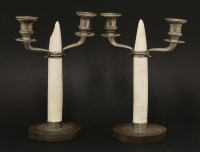 Lot 434 - A pair of Christian Dior faux tusk and silver plated twin branch candelabra