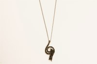 Lot 23 - A 9ct white gold black diamond swirl pendant on a trace chain