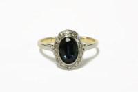 Lot 2 - A gold oval cut sapphire and diamond cluster ring