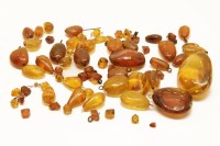 Lot 41 - A collection of graduating amber beads and drop pendants