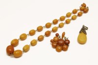 Lot 83 - A rolled gold link single row graduated amber bead necklace