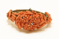 Lot 45 - An early 20th century metal twig coral hinge  bracelet