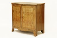 Lot 473 - A walnut bow fronted two door side cabinet