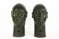 Lot 358 - A pair of bronze Ife heads with line detail