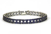 Lot 30 - A white gold three row sapphire line bracelet