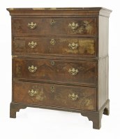 Lot 637 - A walnut and feather banded chest of drawers