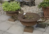 Lot 1021 - A pair of cast iron planters