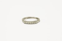 Lot 52 - A 9ct white gold seven stone diamond half hoop ring