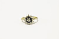 Lot 116 - An 18ct gold diamond and sapphire cluster ring