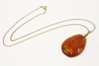 Lot 130 - A Russian gold amber drop pendant