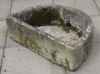 Lot 1032 - A carved limestone stone d-shaped basin