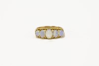 Lot 120 - A gold five stone graduated opal cabochon boat shaped ring