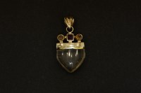 Lot 88 - A gold carved rock crystal and amethyst citrine cap pendant