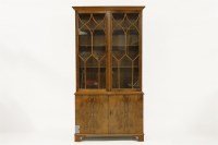 Lot 642 - A Bevan and Funnell yew wood bowfronted bookcase
