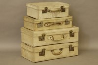 Lot 429 - A set of four graduated vellum suitcases