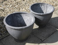 Lot 1111 - A pair of small circular cast lead planters