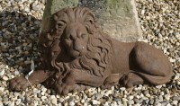 Lot 1098 - A 20th century cast iron figure of a recumbent lion