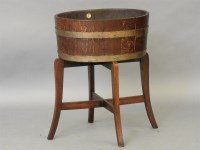 Lot 645 - An oak oval planter on stand