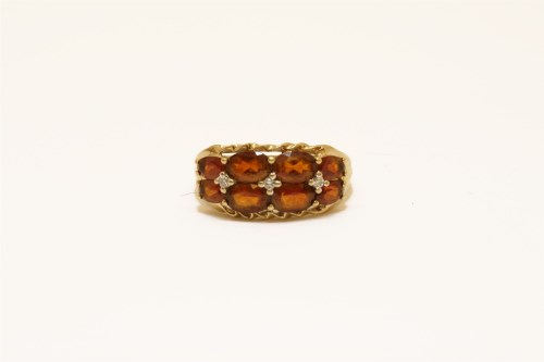 Lot 31 - A 9ct gold two row Madeira citrine and diamond points ring