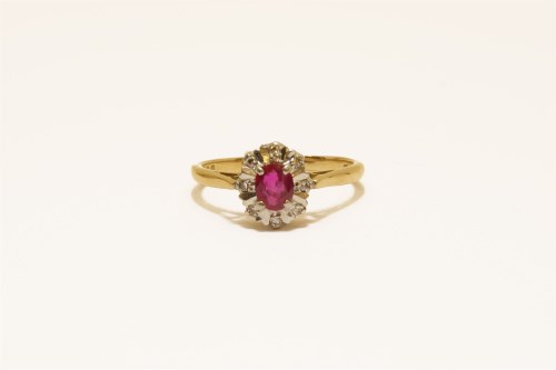 Lot 28 - An 18ct gold ruby and diamond illusion set cluster ring