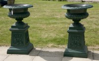 Lot 1064 - A pair of cast iron garden urns