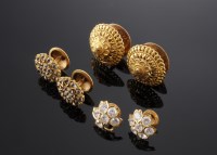 Lot 516 - Three pairs of Indian high carat gold earrings