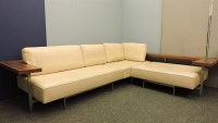 Lot 488 - A large cream leather upholstered modernist corner settee