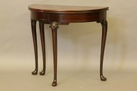 Lot 572 - An early 20th century mahogany demi lune table