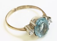 Lot 1000 - An aquamarine and diamond three stone ring