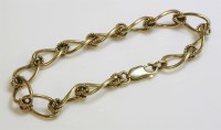 Lot 1029 - A 9ct gold open curb and twisted wire link bracelet