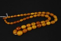 Lot 63 - A single row of graduated amber beads