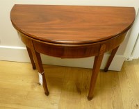 Lot 568 - A George III mahogany and satinwood fold over tea table