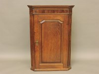 Lot 603 - An oak corner cabinet