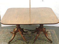 Lot 738 - A Regency style mahogany twin pillar dining table