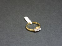 Lot 220 - An 18ct yellow and white gold three stone diamond crossover ring