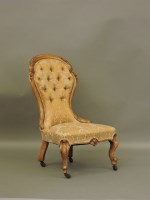 Lot 644 - A Victorian walnut spoon back nursing chair