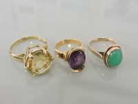 Lot 29 - A gold oval synthetic cut purple sapphire ring