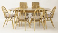 Lot 545 - An Ercol light elm dining table