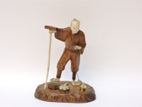 Lot 1335 - A late 19th century Japanese wood and ivory sarumawashi