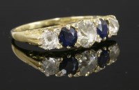 Lot 376 - A late Victorian five stone diamond and sapphire carved head ring