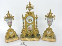 Lot 285 - A gilt and porcelain mounted clock garniture