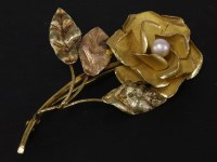 Lot 49 - A gold single pearl floral brooch