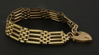 Lot 158 - A gold four bar gate textured chased decorated link bracelet