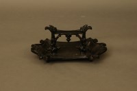 Lot 3095 - A Victorian cast iron and black painted boot scraper 42cm wide