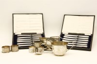 Lot 157 - A set of three cast and engraved silver napkin rings