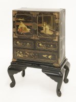 Lot 391 - A Japanese lacquered cabinet on stand